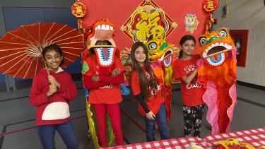 Clearbrook Student Display Students dressed in red and wearing or holding items to celebrate Lunar New Year.