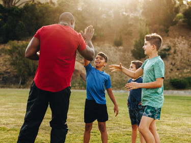 Coach high fives a student