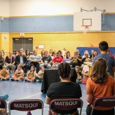 3 male students present to entire school and community members in the gym