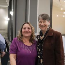 Two women pose for a photo