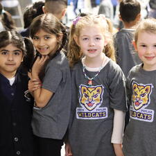 Four K students stand and pose for photo